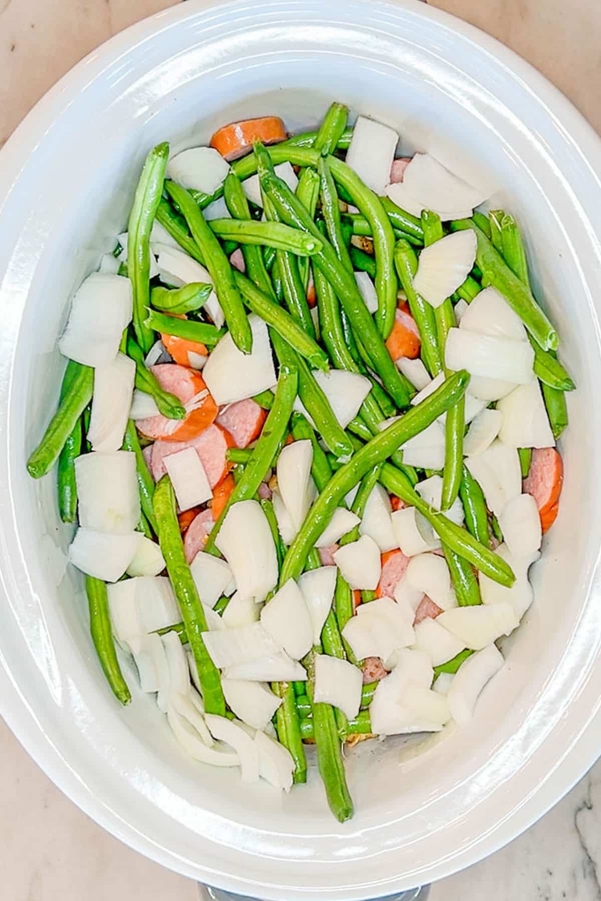 Step 2 for Crockpot Sausage and Potatoes - add the vegetables and sausage