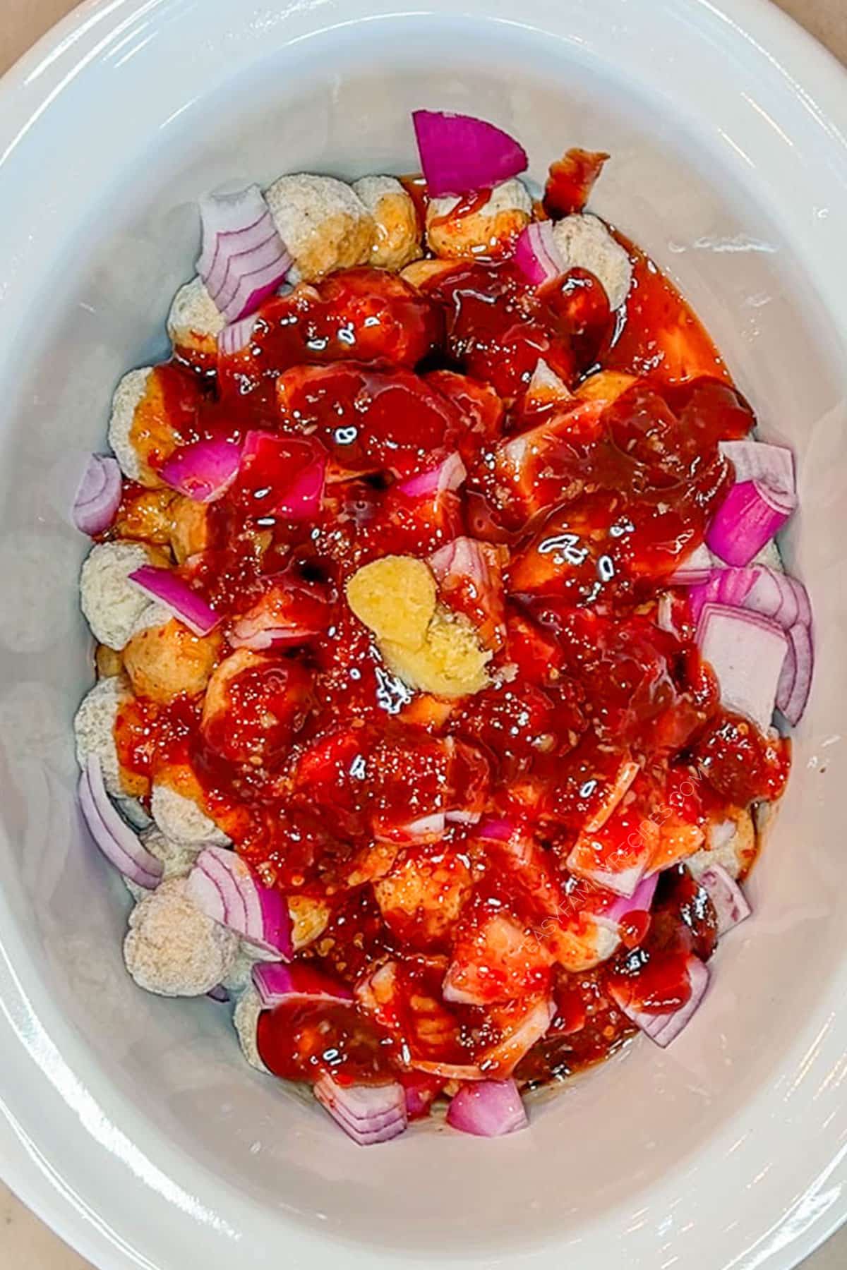 Step 3 for how to make Crockpot Sweet Chili Meatballs - add sweet chili sauce