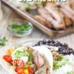 A white plate with a serving of sheet pan steak fajitas. The text reads, “Sheet Pan Steak Fajitas”