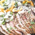 Tender flank steak and veggies for sheet pan steak fajitas. The text reads, “Sheet Pan Steak Fajitas”