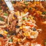 A spoon scoops out a serving of Crockpot Chicken Taco Soup. The text reads “Crockpot Chicken Taco Soup”