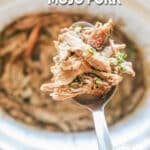 A serving spoon scoops out mojo pork from a slow cooker. The text reads, “Crockpot Cuban-Style Mojo Pork”