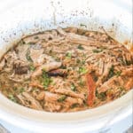 Crockpot Cuban Style Mojo Pork top view in a white Crock Pot