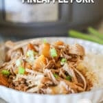 Crockpot pineapple pork served in a white bowl with a side of white rice.