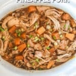 Pineapple pork in a white crockpot after cooking.