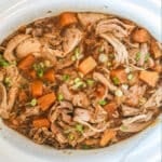 Finished pineapple pork recipe in a white crockpot.