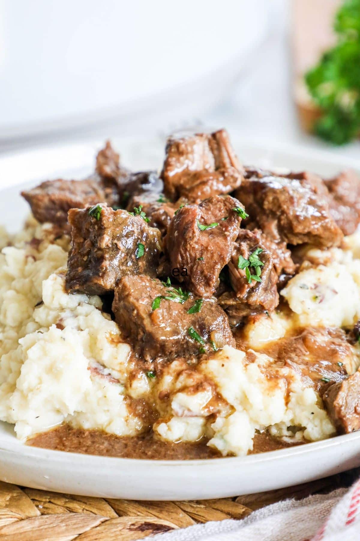 steak bites over mashed potatoes on a plate