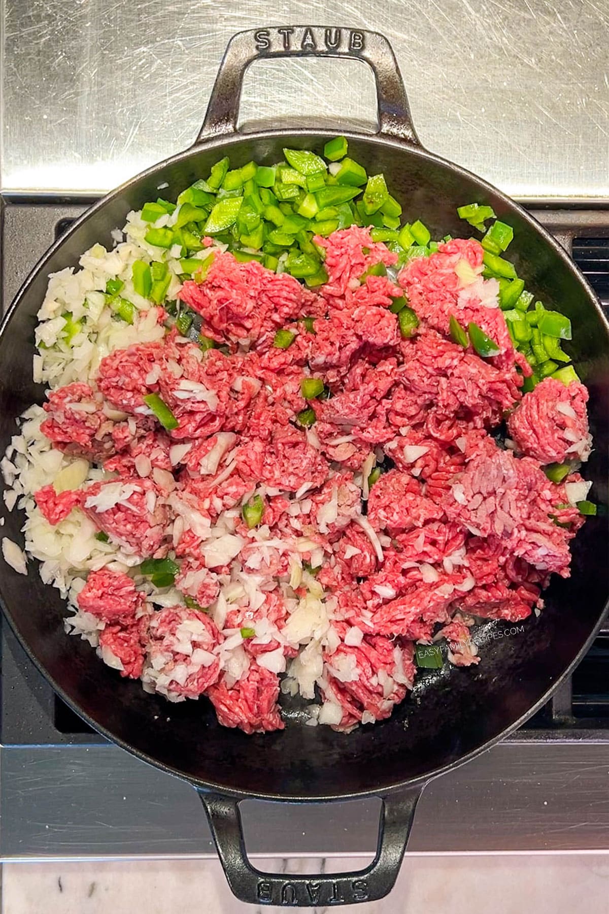 Step 2 of how to make Cowboy Casserole - cook the ground beef, onions, and peppers