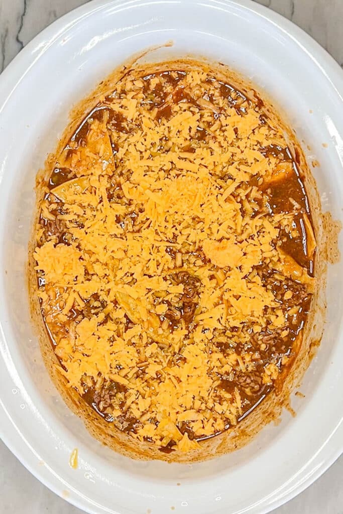 enchilada casserole topped with shredded cheese.