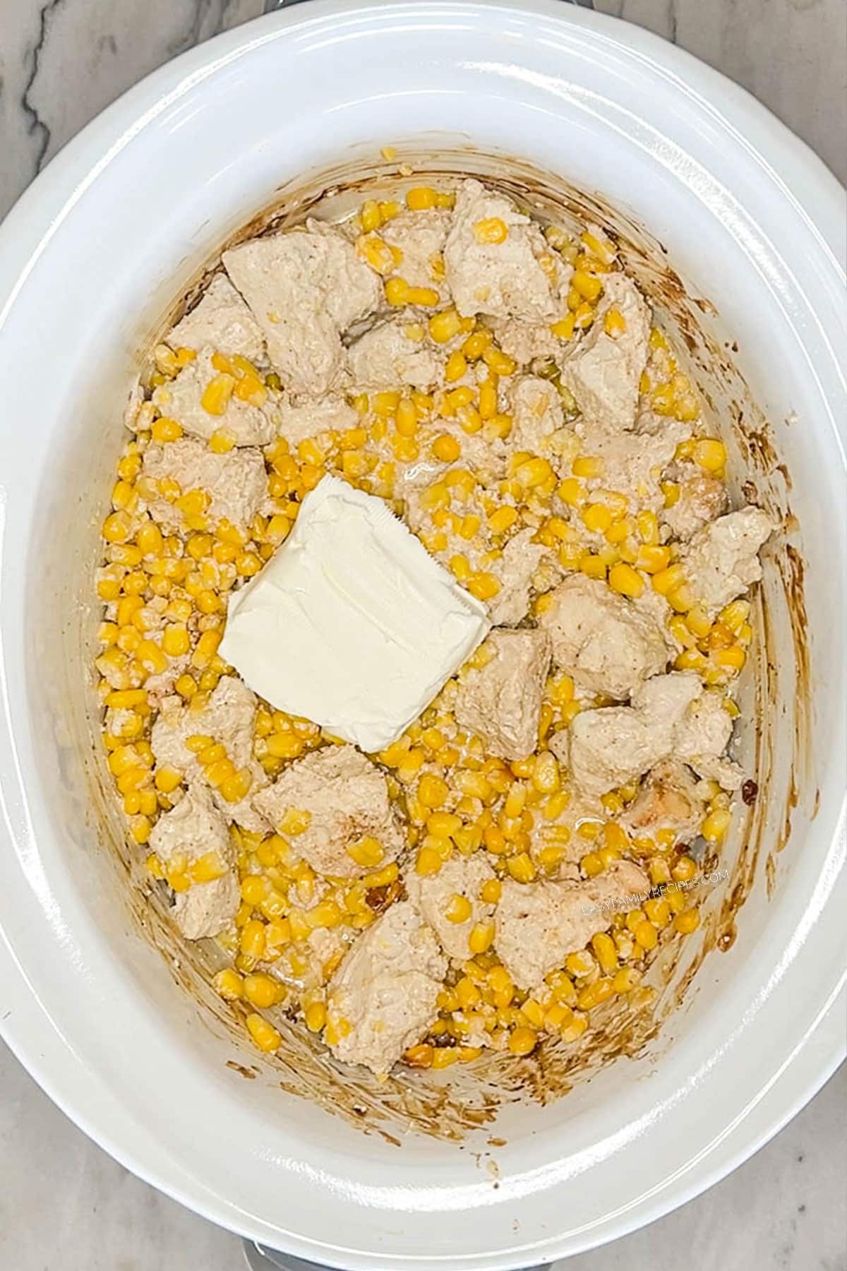 Step 3 for how to make Crockpot Mexican Street Corn Chicken: Add cheese
