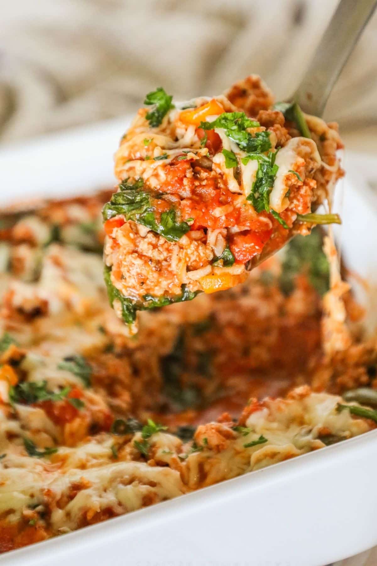 stuffed pepper casserole with a spoonful being lifted up