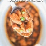 A serving of Crockpot Orange Chicken is lifted from the Crockpot. The text reads, “Crockpot Orange Chicken”