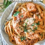 Top view of a bowl of Crockpot Sun Dried Tomato Chicken Alfredo. The text reads, “Crockpot Sun Dried Tomato Chicken Alfredo”