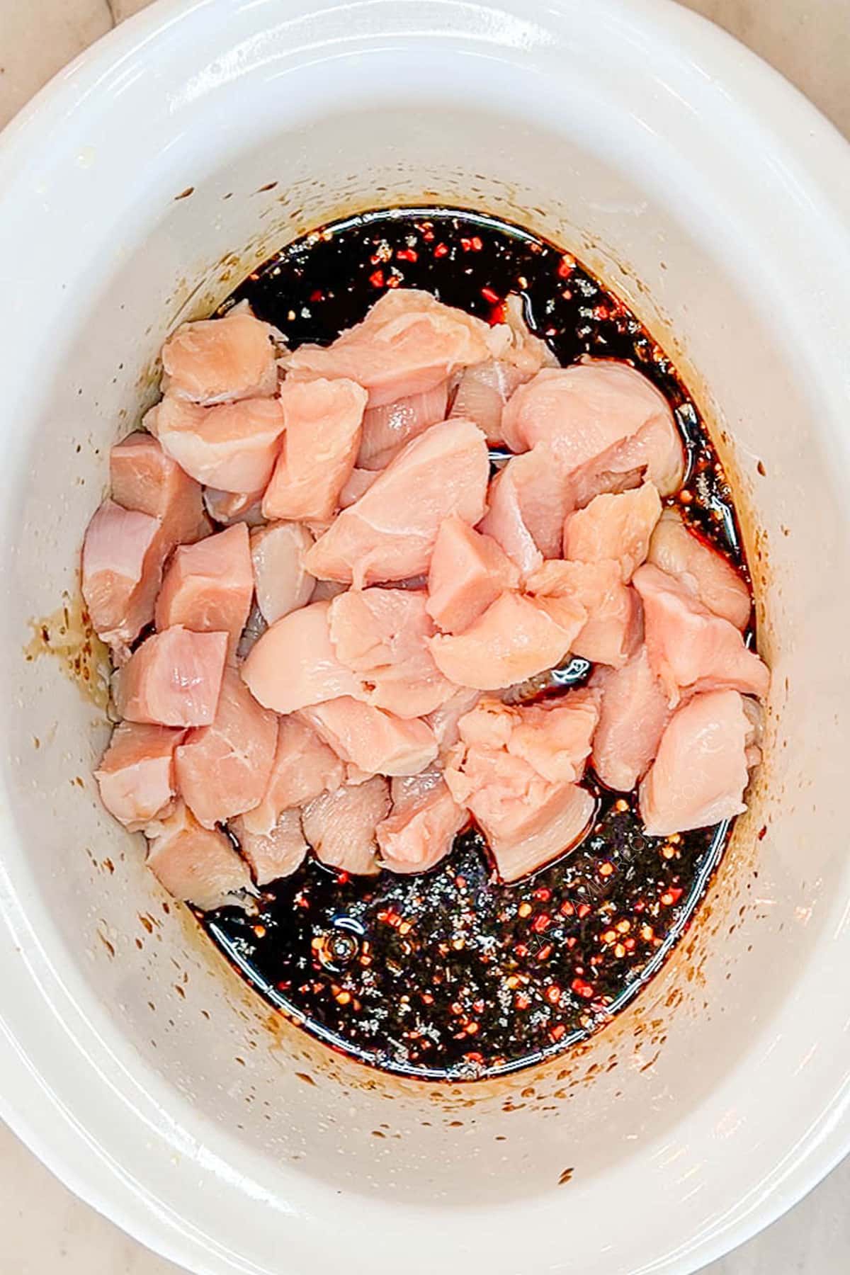 Step 2 for how to make Crockpot Orange Chicken - add sauce ingredients and chicken