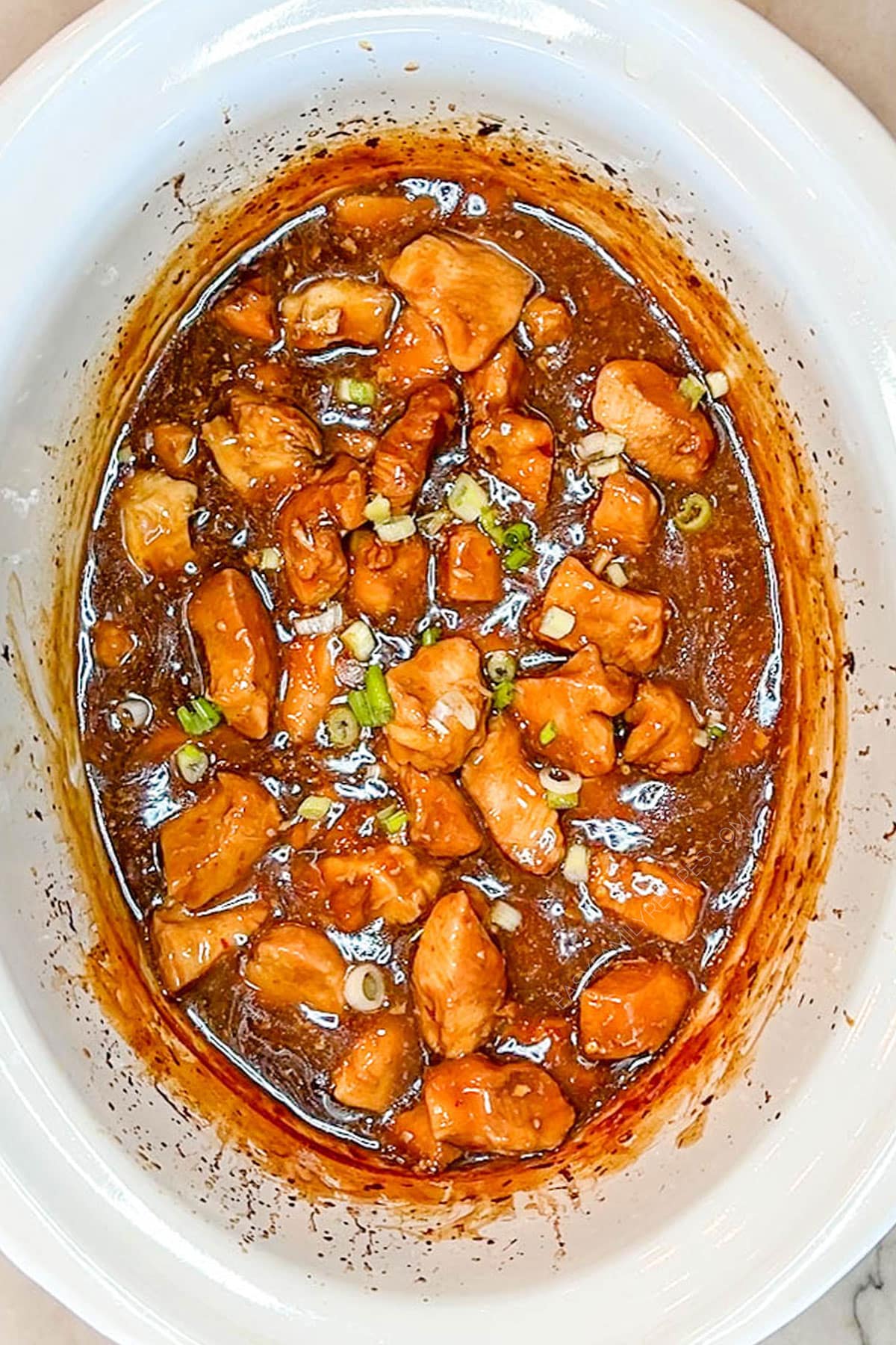 Step 4 for how to make Crockpot Orange Chicken - cook until the chicken is cooked through and the sauce is thickened