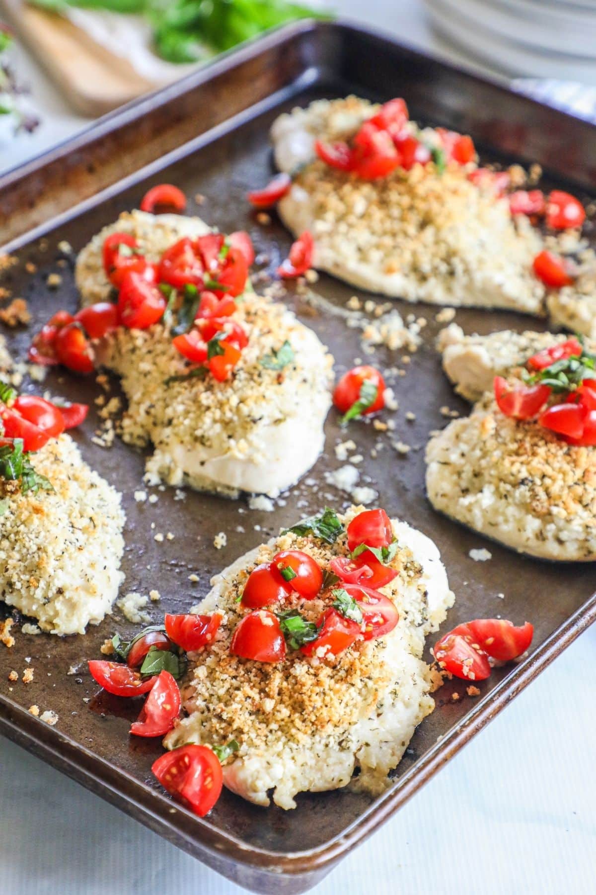 italian baked chicken breasts on a baking sheet