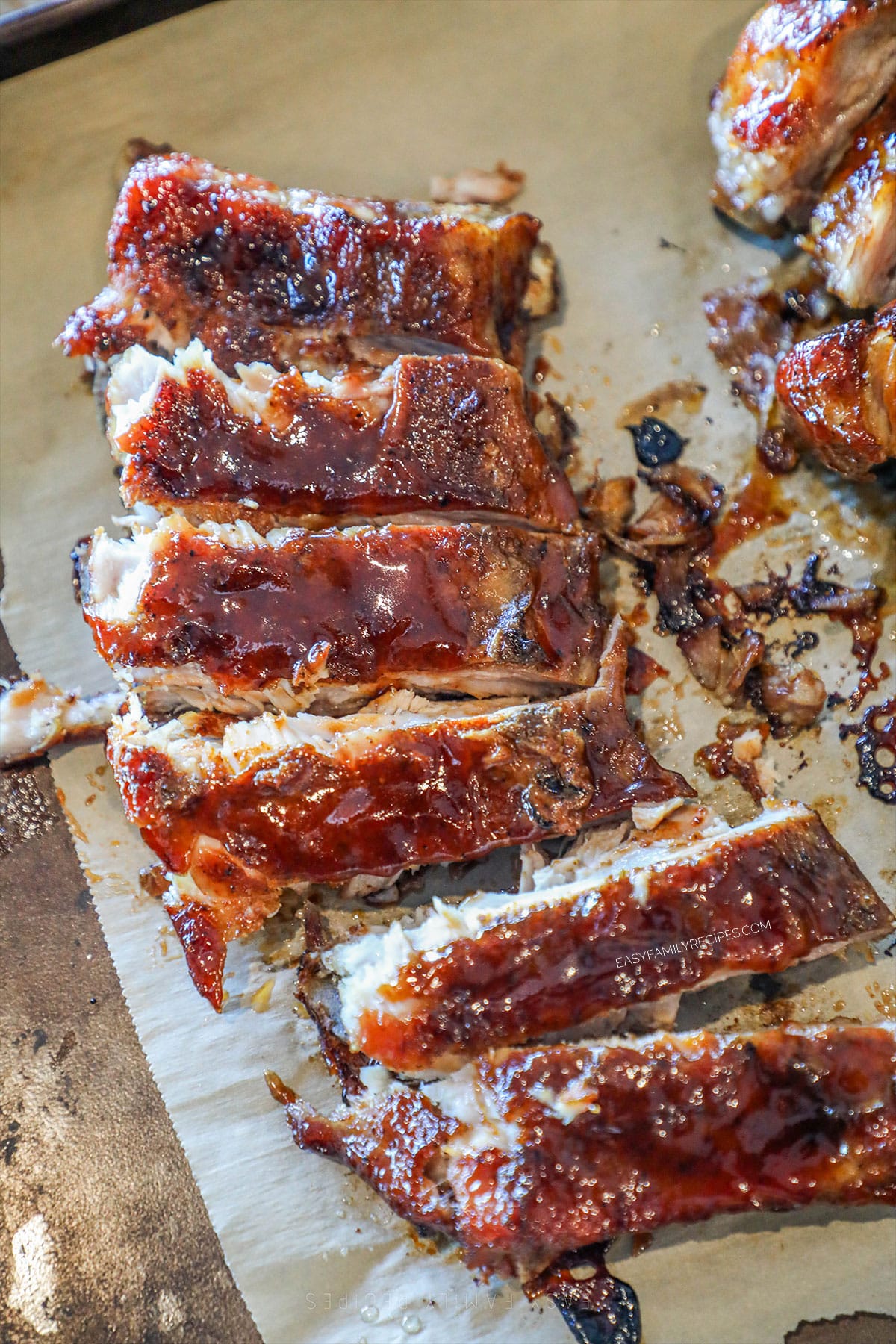 above image of sliced honey bbq ribs on a cutting board.