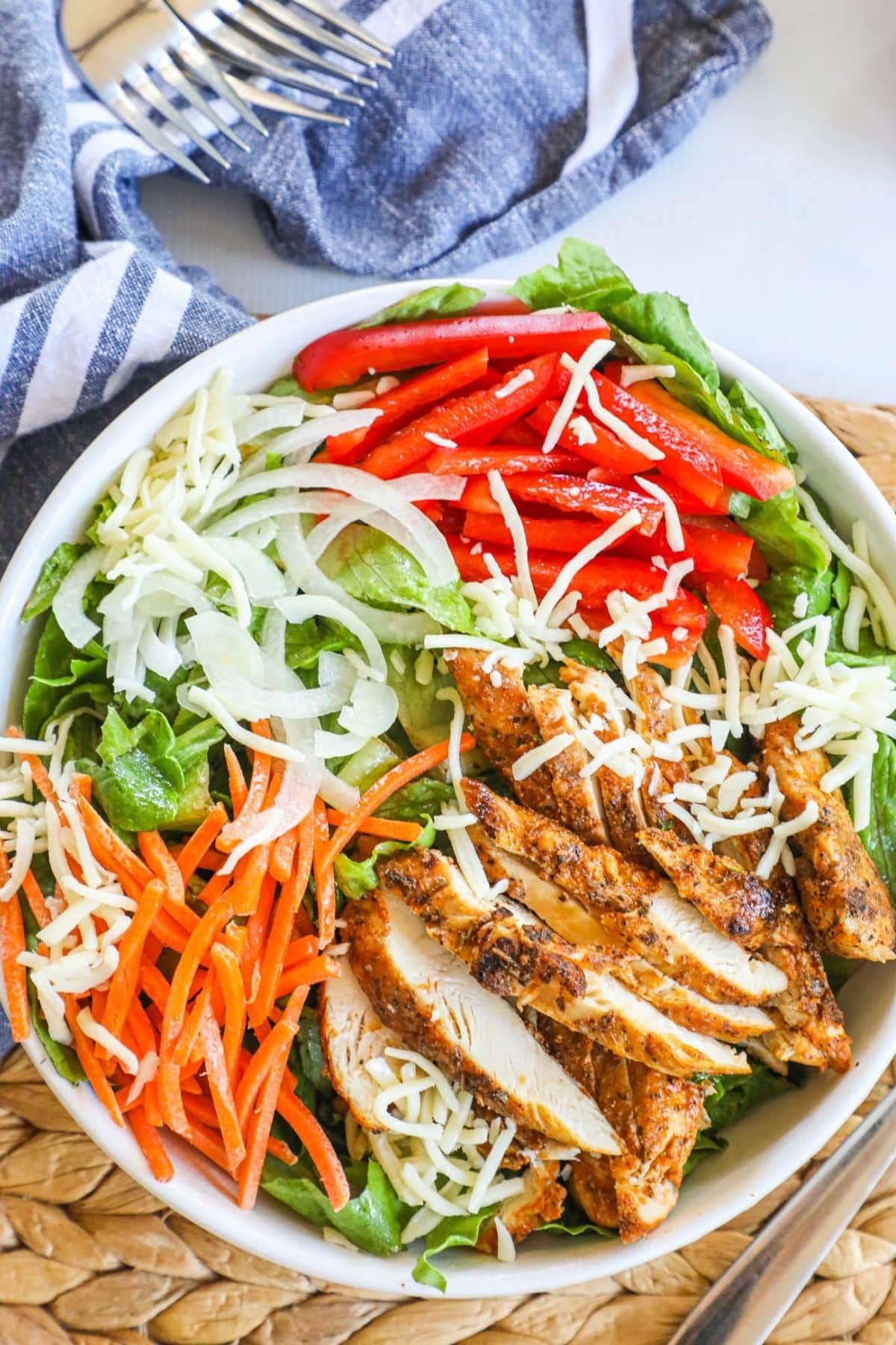 blackened chicken salad in a white bowl