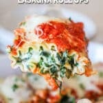 Side view of a chicken spinach lasagna roll up on a spatula hovering in the air.