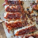 above image of sliced honey bbq ribs on a cutting board.