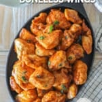 Overhead shot of honey barbecue boneless wings served on a cast iron skillet.