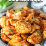 Honey BBQ boneless chicken wings served on cast iron and garnished with parsley.