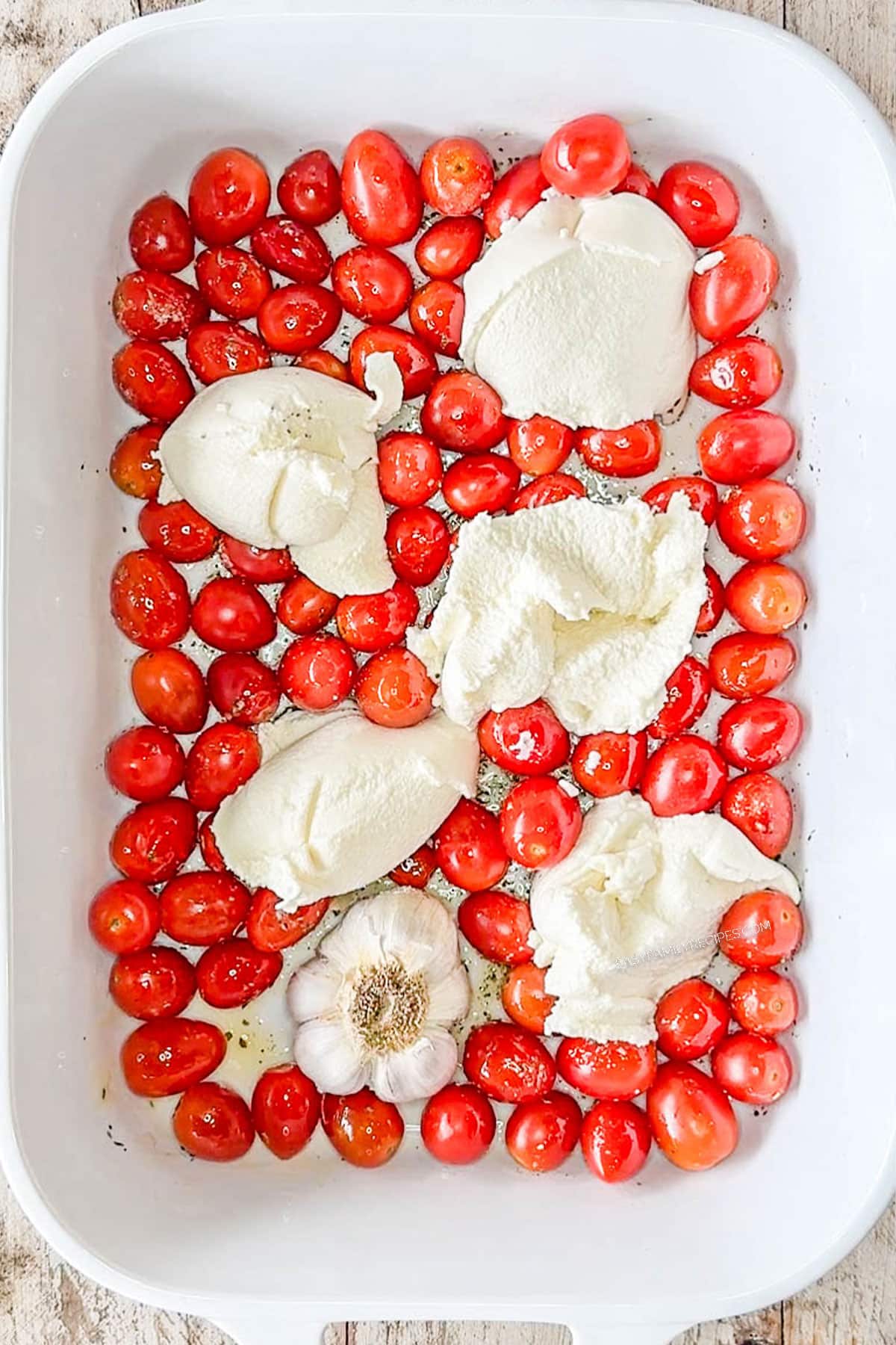 tomato and ricotta with garlic in a baking dish.