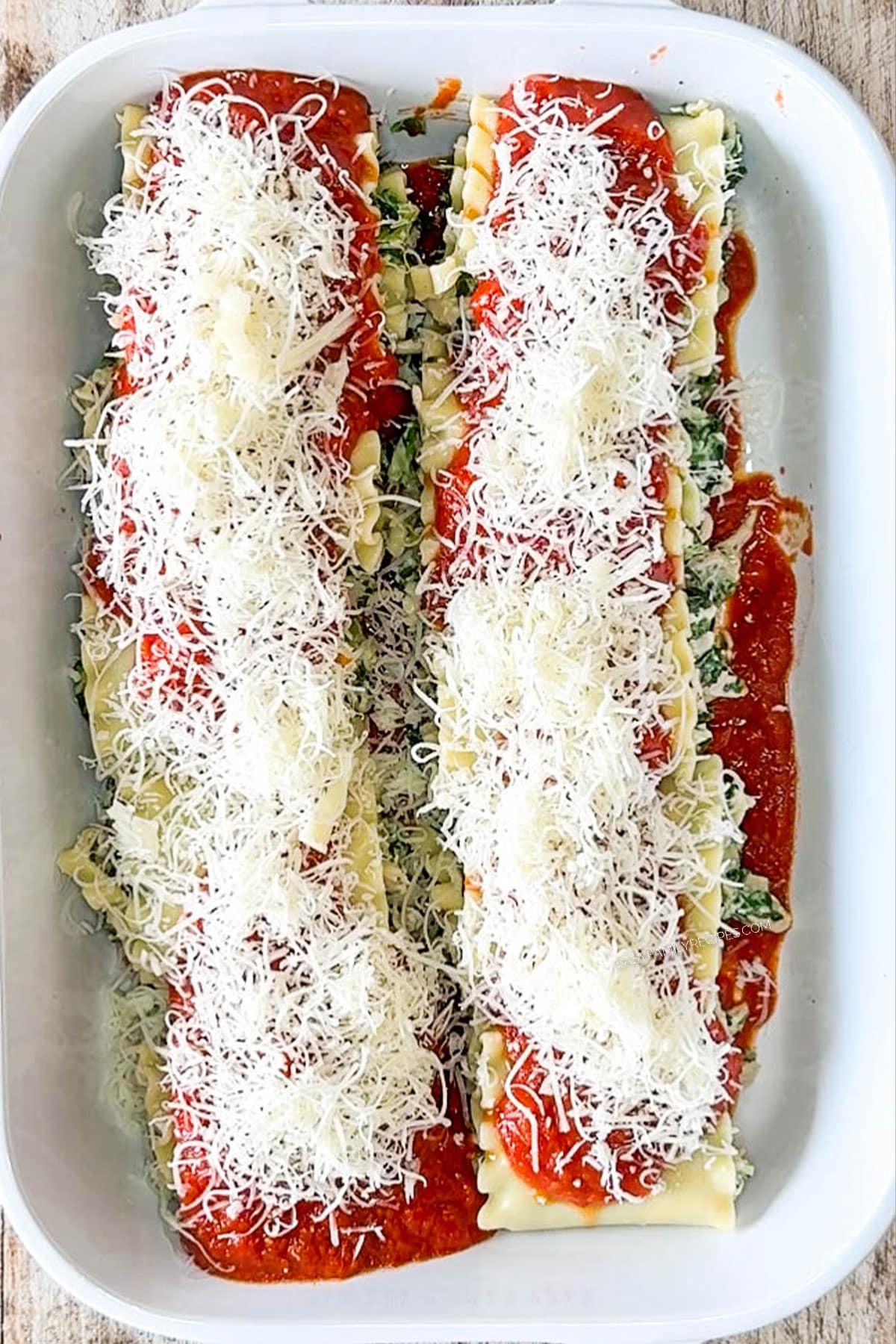Marinara sauce and cheese added on top of the spinach chicken lasagna roll ups.