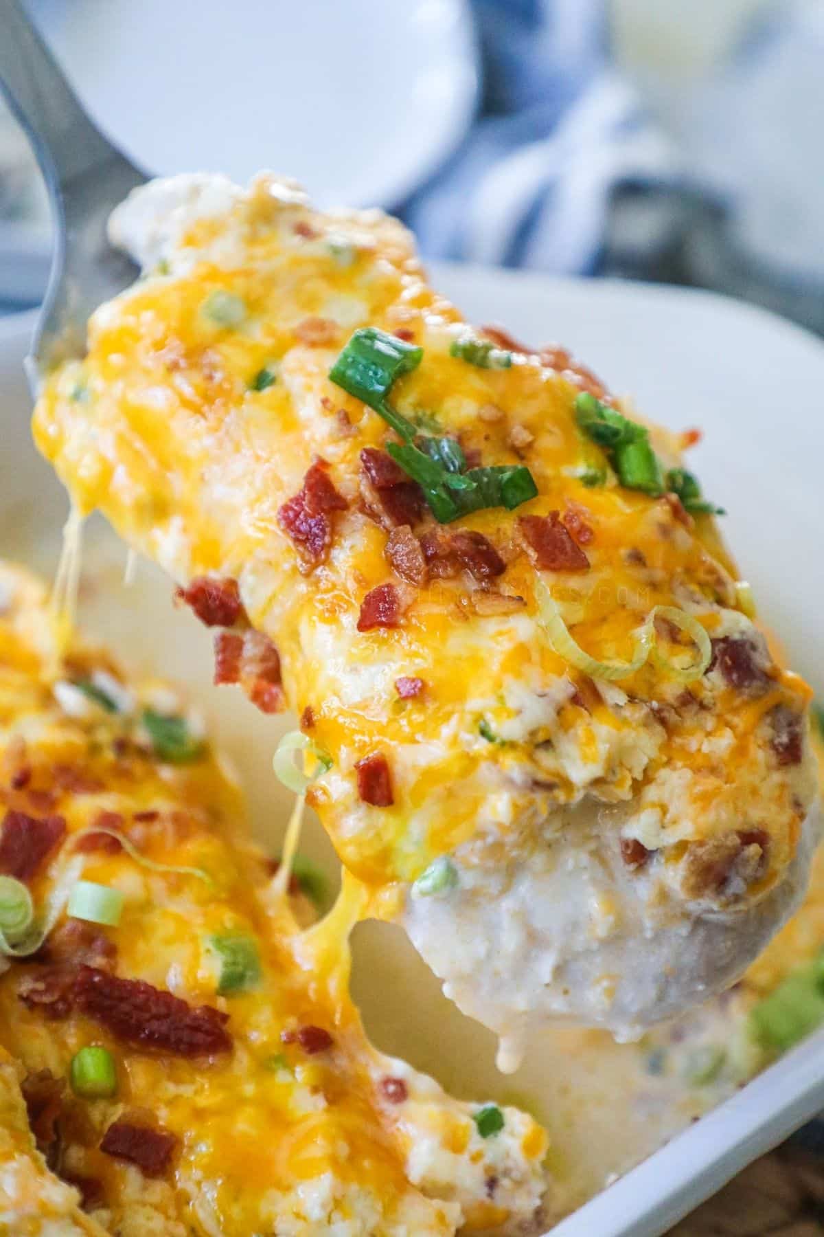 chicken breast from million dollar chicken bake being lifted by spatula from baking dish