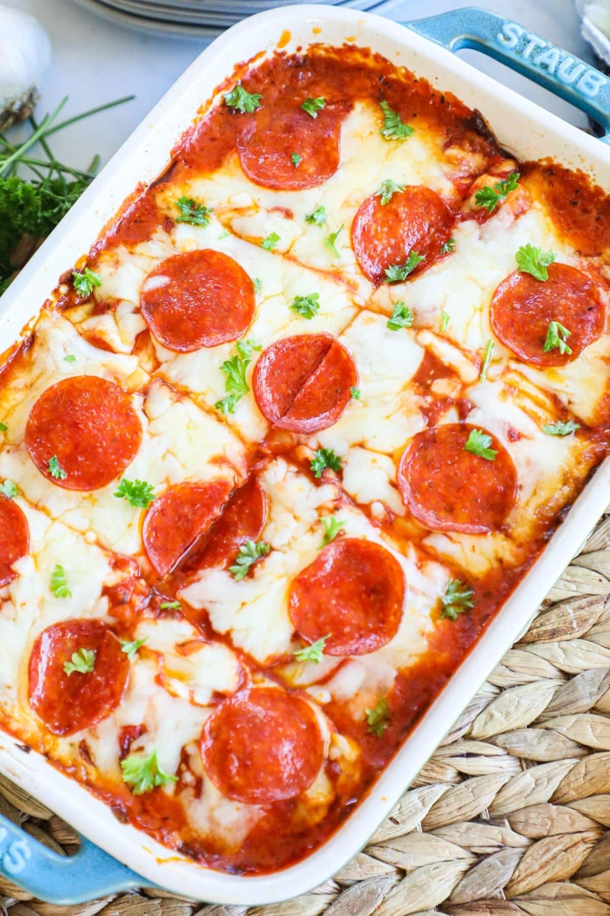 pepperoni ravioli lasagna in a white baking dish