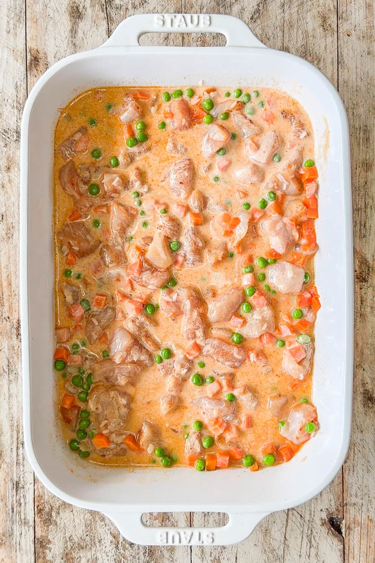 Ingredients for one pan bang bang chicken bake all mixed together in a baking dish before baking.