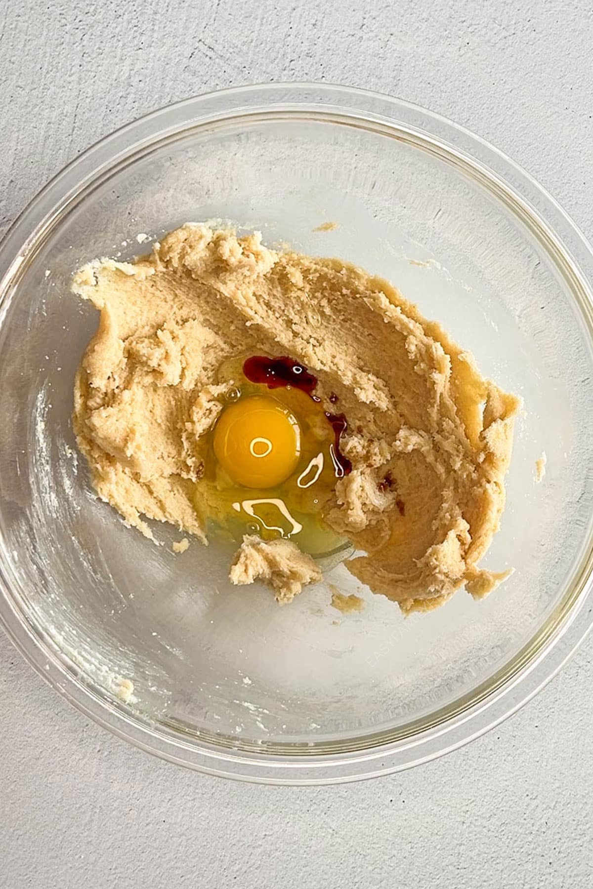 creamed butter and sugar with egg and vanilla in a bowl.