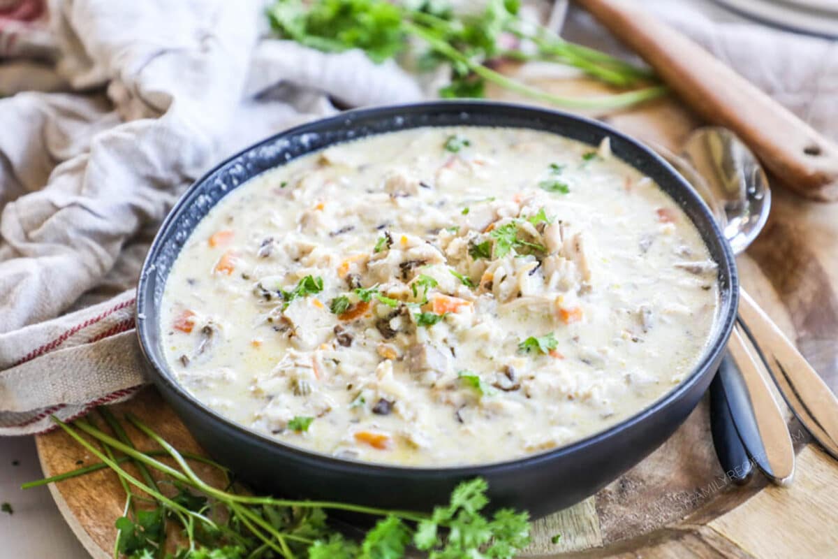 Crockpot Chicken and Wild Rice soup served in a black bowl and ready to eat