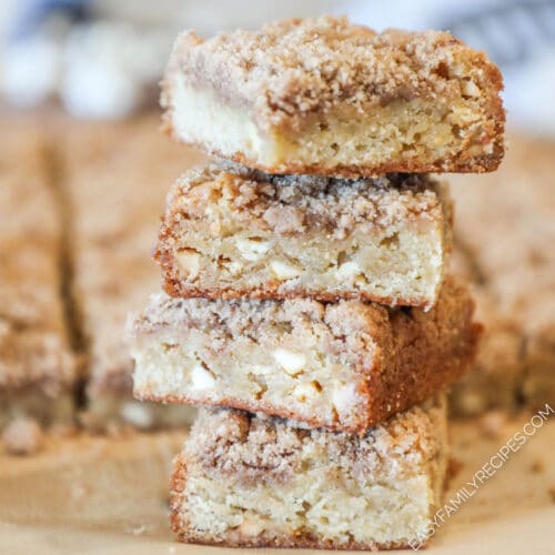 Four cinnamon streusel blondie bars stacked on top of each other.