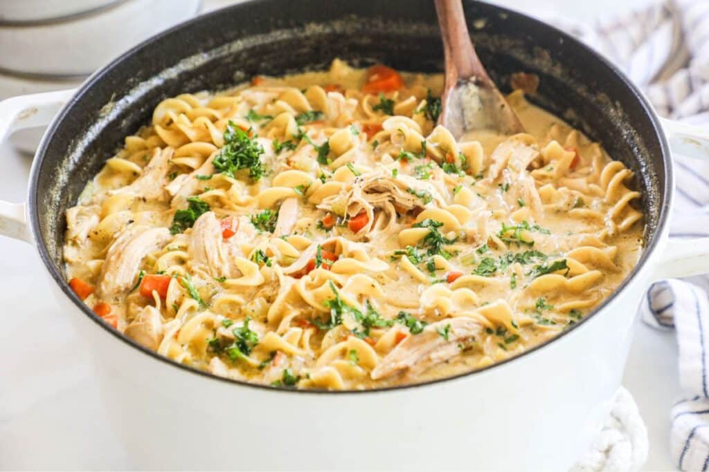 Creamy Chicken Noodle soup recipe prepared in a dutch oven on the stove top.