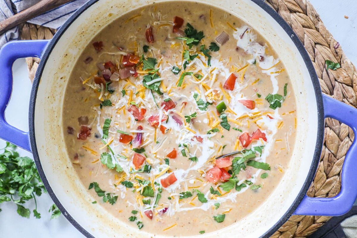 Overhead shot of Creamy chicken tortilla soup in a blue dutch oven