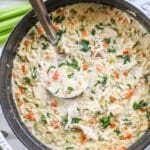 Creamy Lemon Chicken Orzo Soup prepared in a dutch oven.