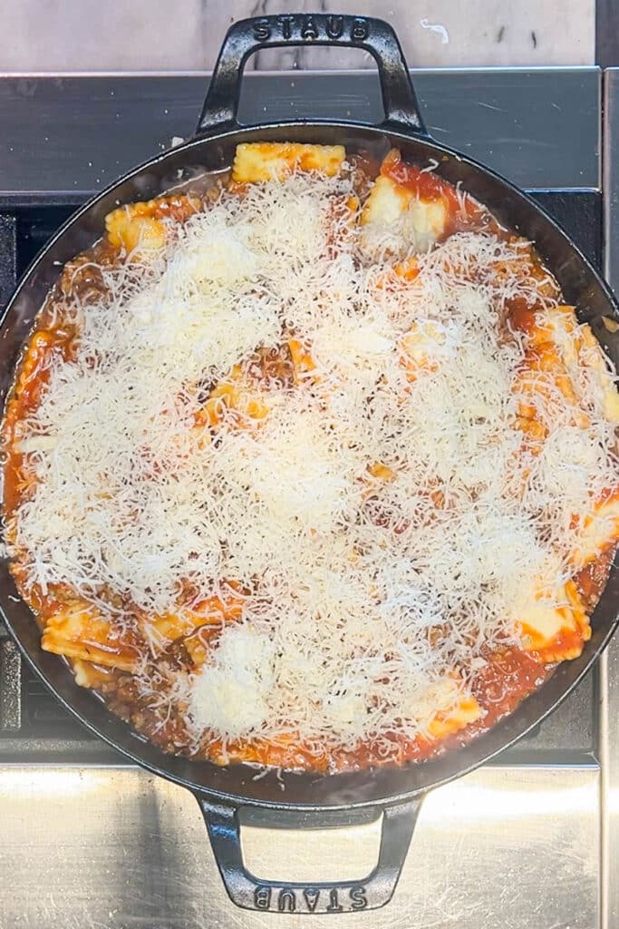 ravioli and sauce topped with mozzarella cheese.