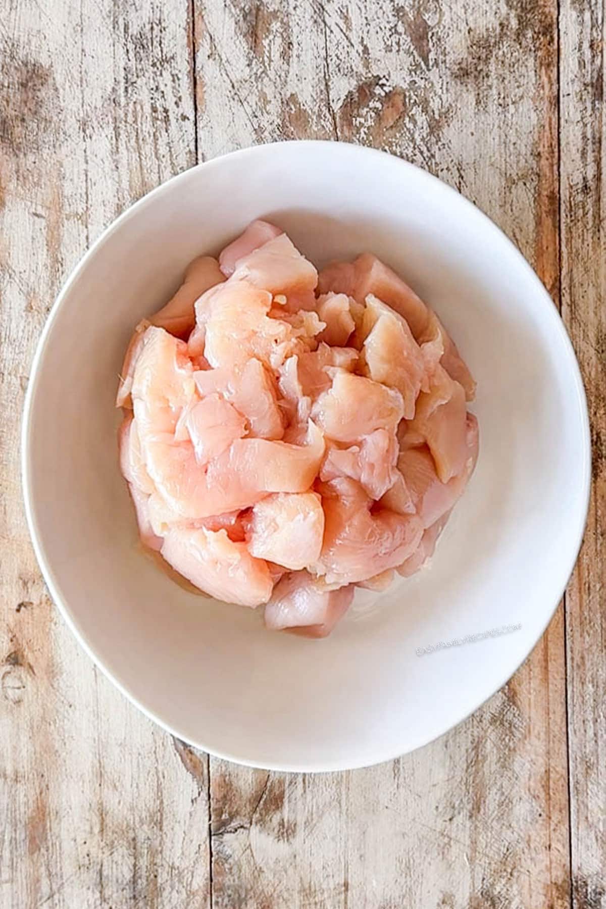 Diced chicken breast in a bowl.