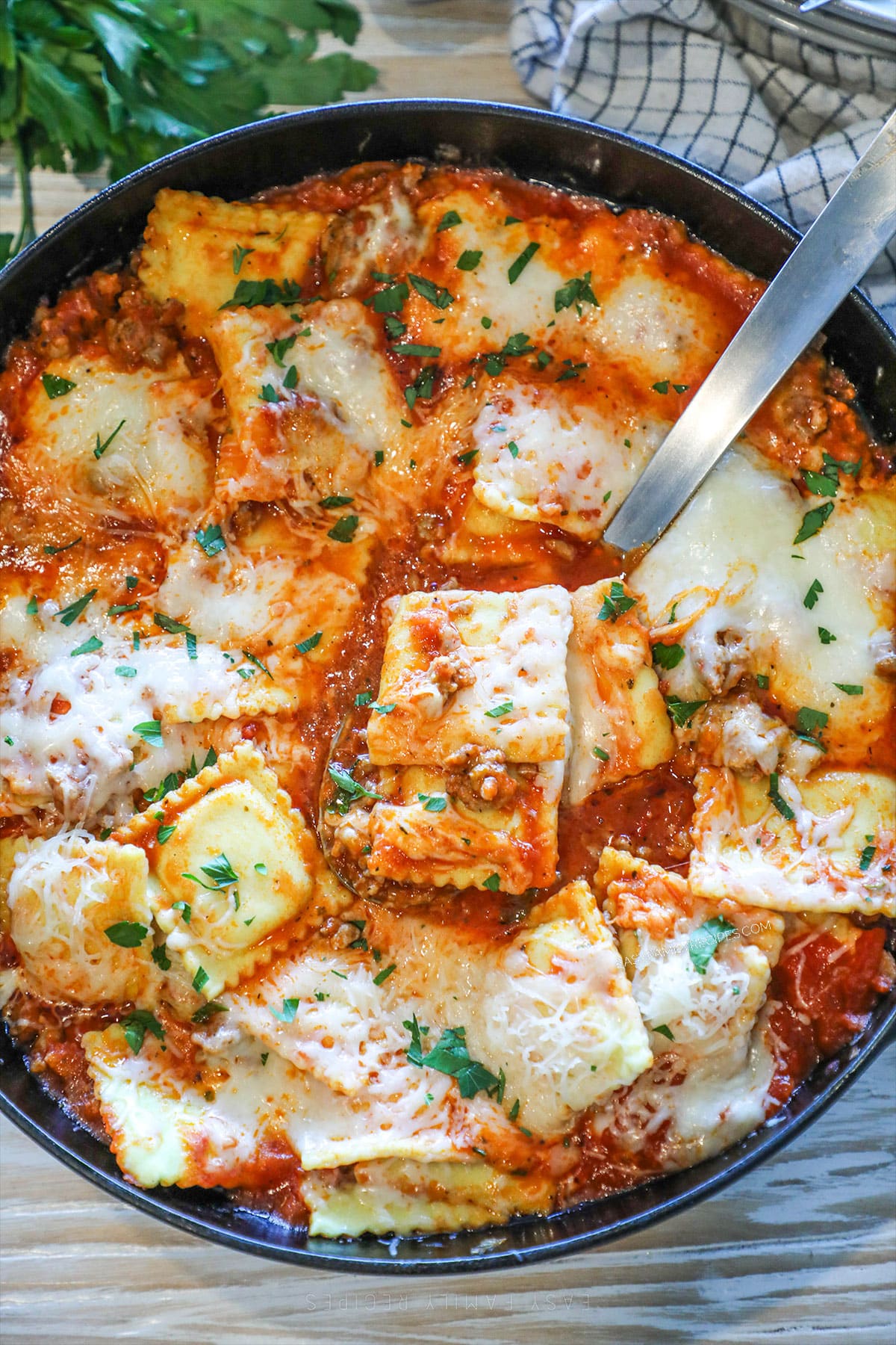 above image of cheesy ravioli in a skillet.