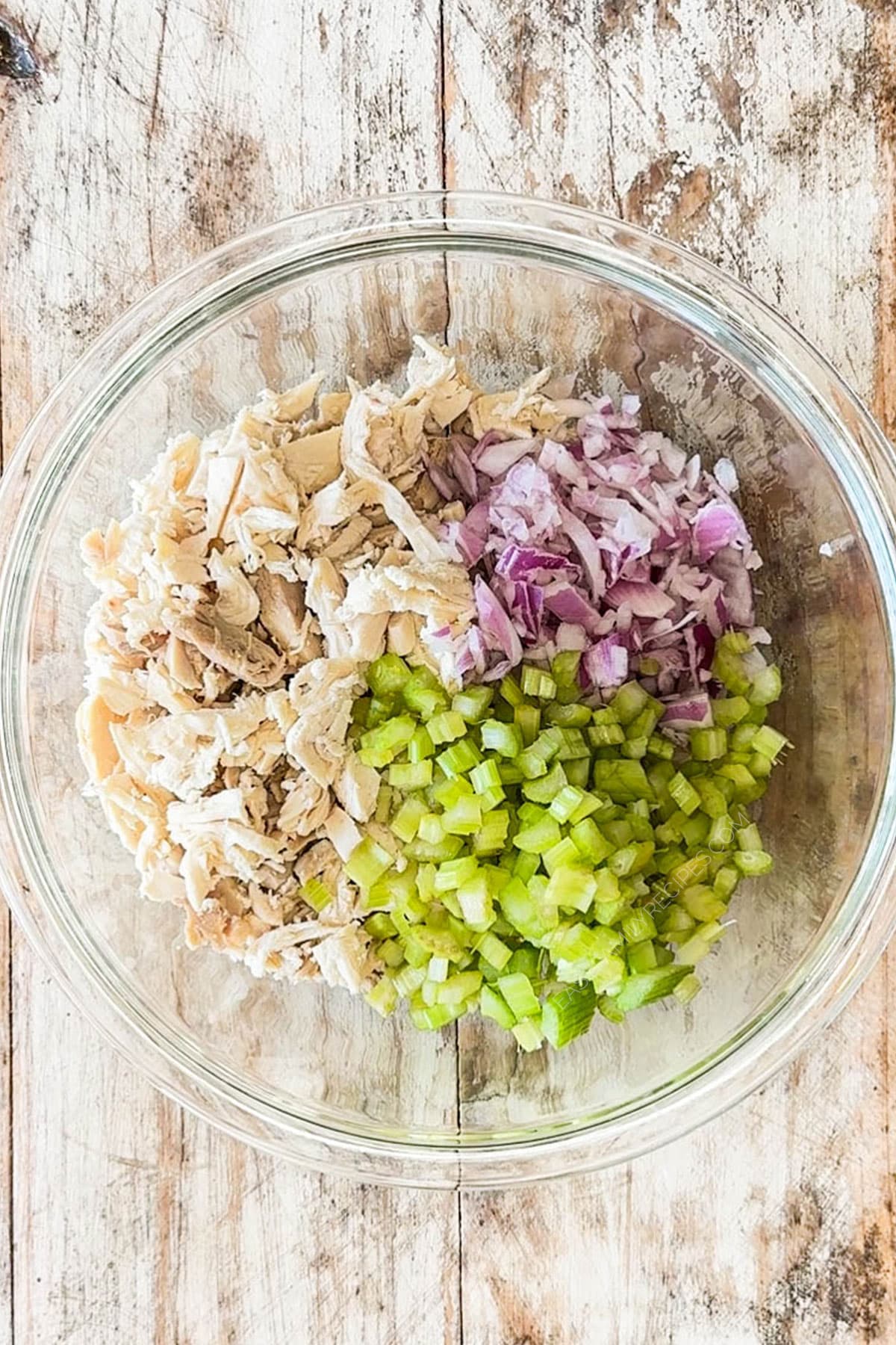 turkey, celery, and red onion in a bowl.
