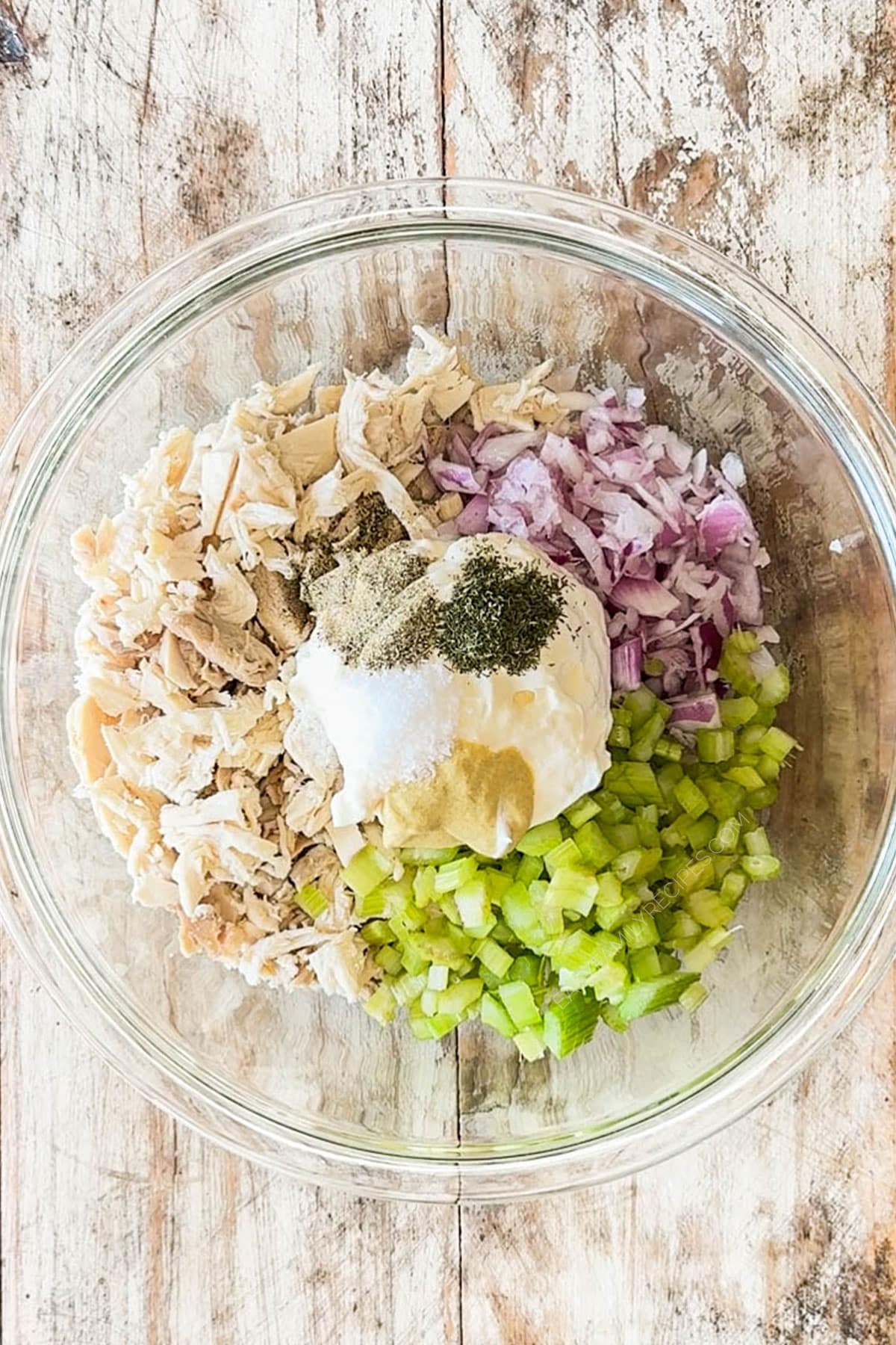 turkey, veggies, and mayo dressing in a bowl.