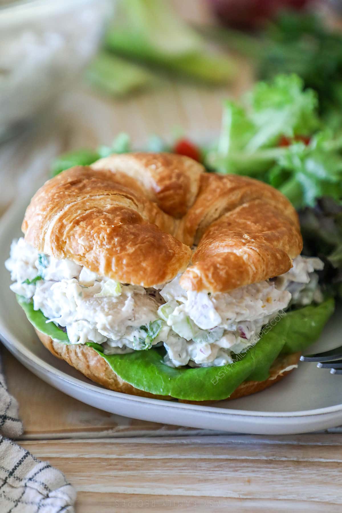 turkey salad piled on a croissant to make a sandwich.