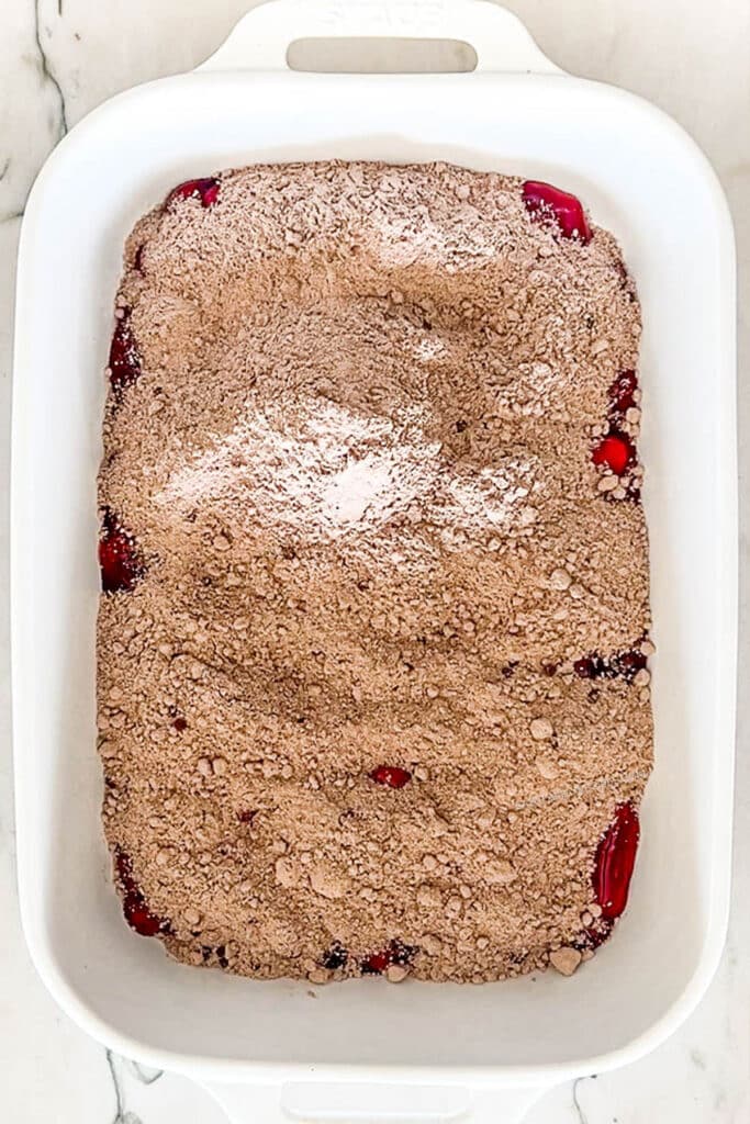 cake mix sprinkled over cherry pie filling.