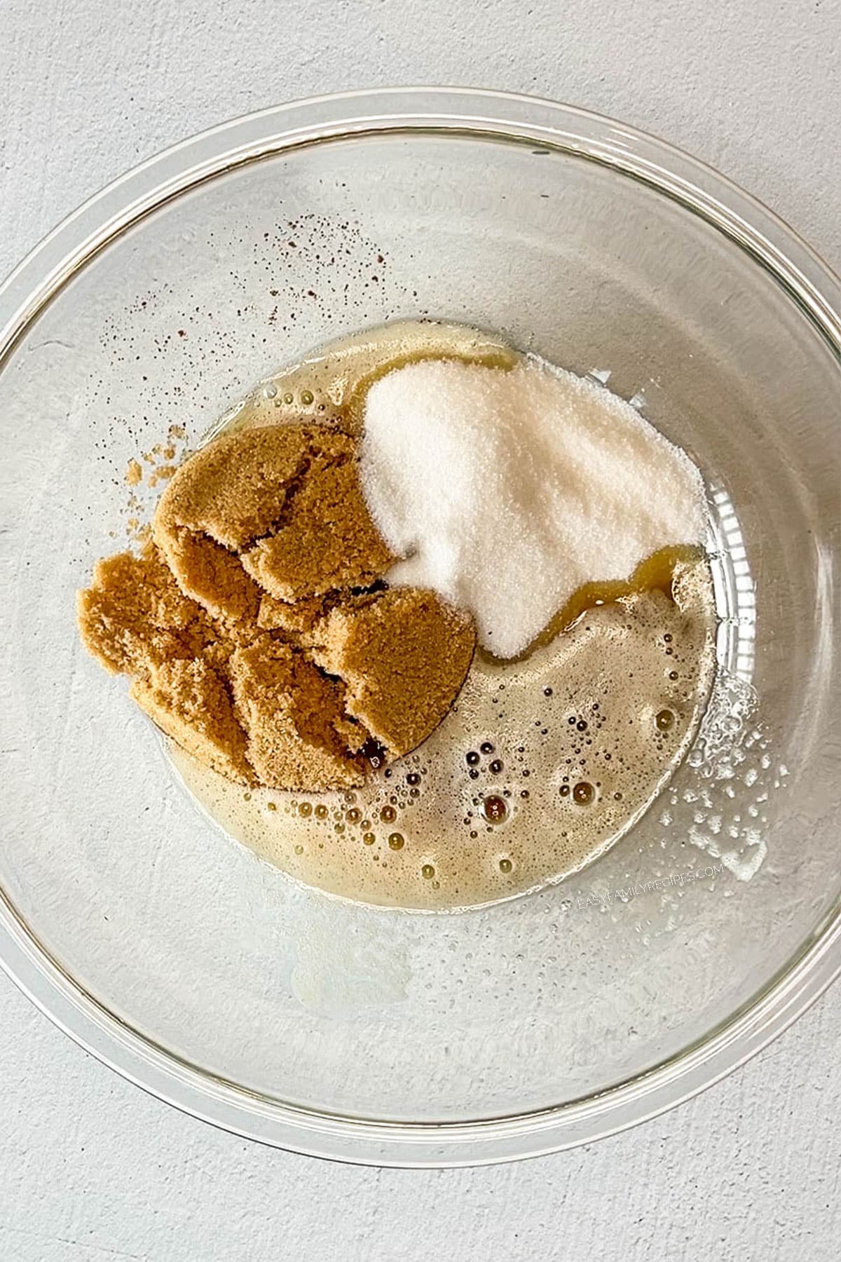 glass bowl of browned butter, brown sugar and white sugar