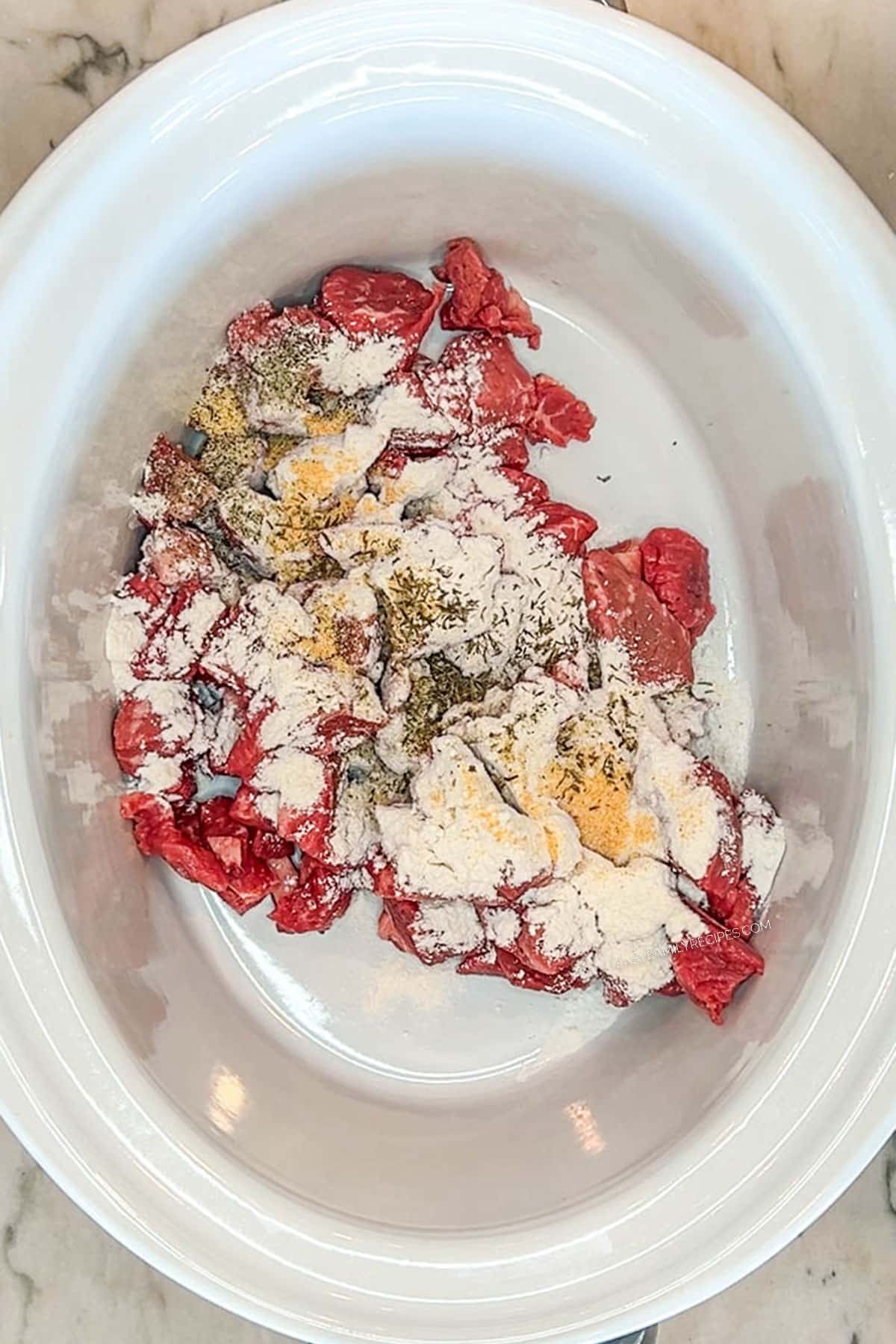 stew meat with seasonings to be tossed- in white crockpot