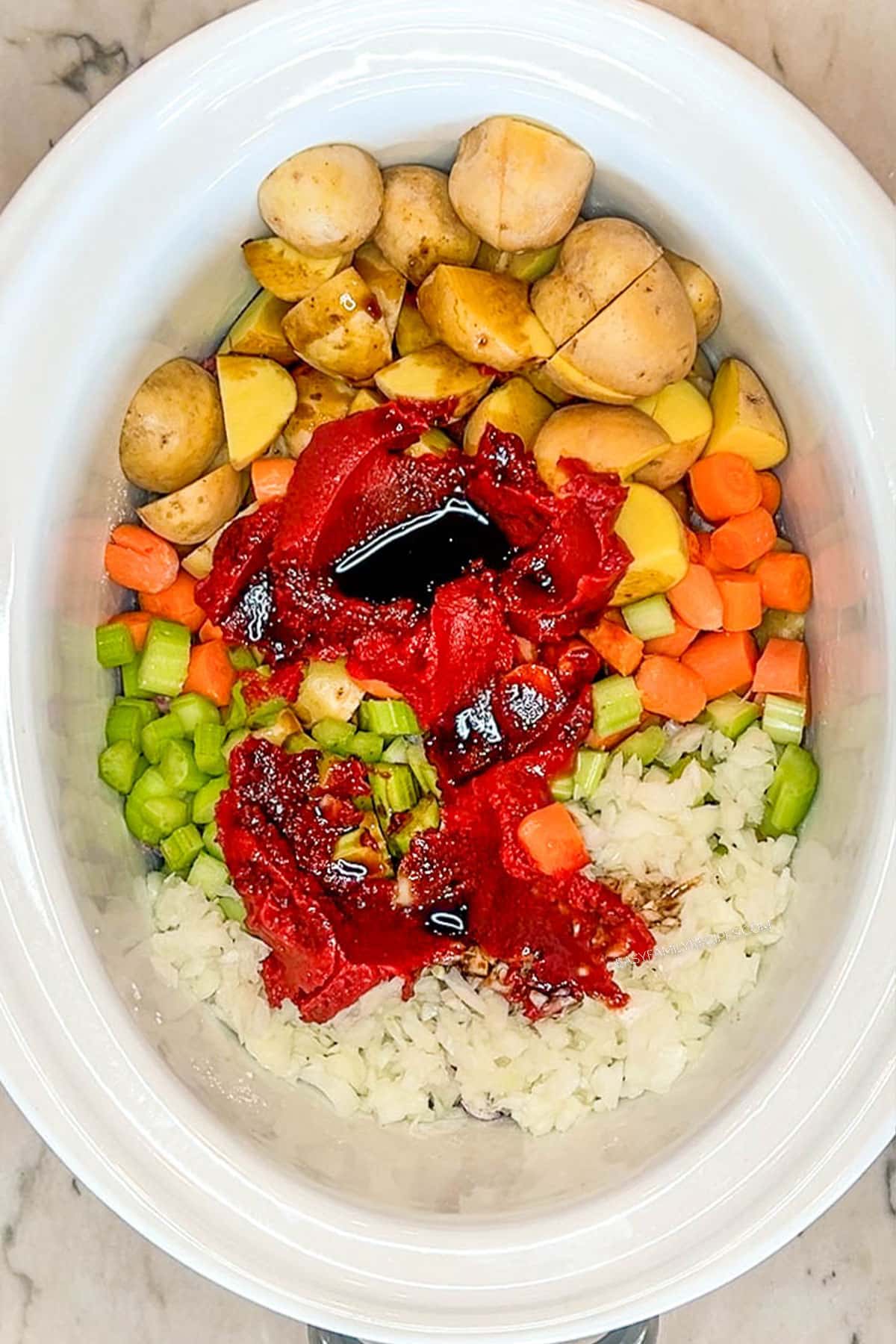 uncooked ingredients in slow cooker beef stew before it has simmered