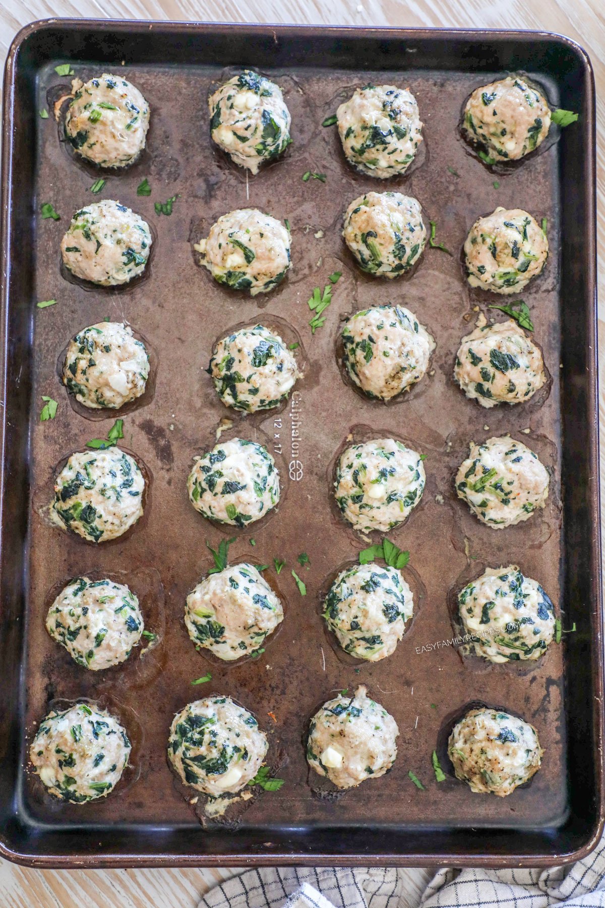 Spinach feta turkey meatballs on a sheet pan after being baked.