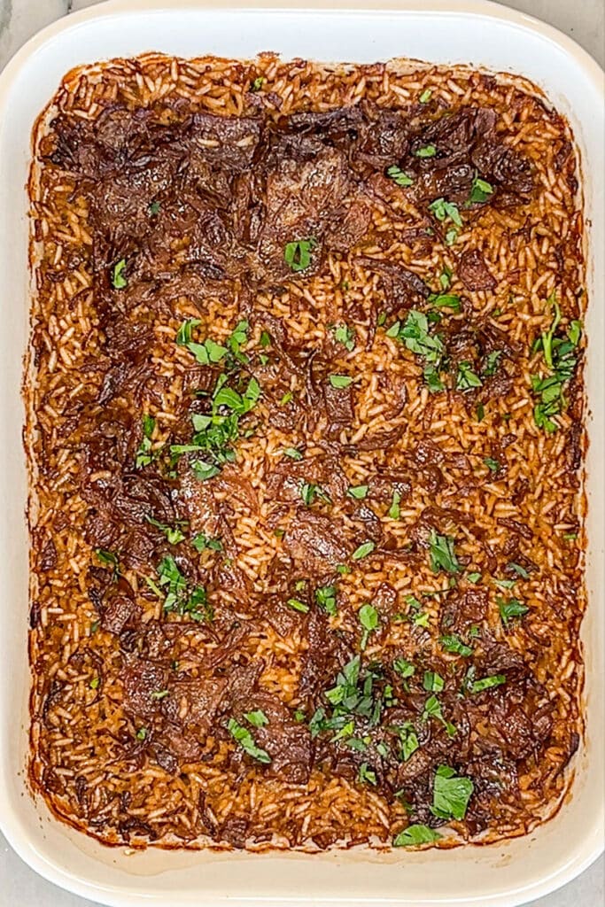 finished stick of butter rice in a baking dish.