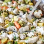 closeup of a mix of chopped chicken, carrots, potatoes, and green beans on a pan.